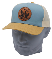 Blue and beige cap with a leather patch on a mannequin head against a white background
