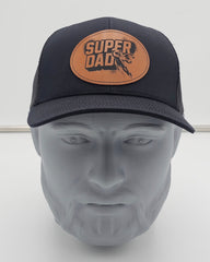 Black cap with 'Super Dad' leather patch on a mannequin head against a white background