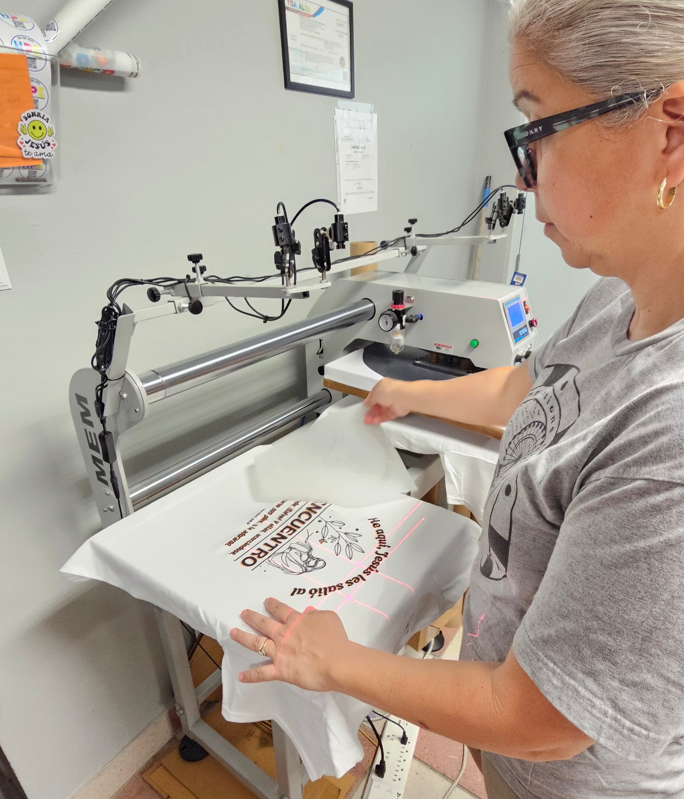 Person using a heat press machine in a workshop setting
