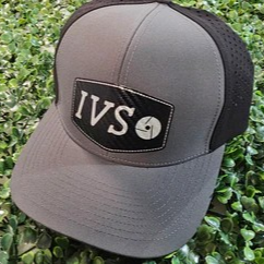 Gray cap with black brim and 'IVS' logo on a green leaf background