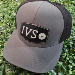 Gray cap with black brim and 'IVS' logo on a green leaf background