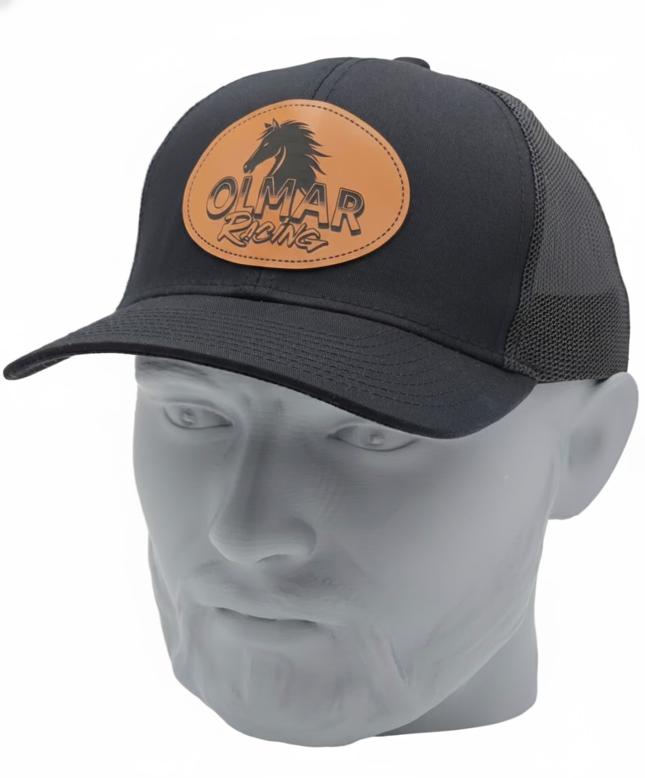 Black cap with leather patch featuring 'Olmar Rides' on a mannequin head against a white background